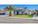 Cozy single-story home with charming accents, lush green lawn and a mature palm tree at 5767 Tabitha Ave, Las Vegas, NV 89156