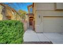 A cozy front entrance featuring a gated courtyard that leads to a charming red front door at 8040 Marshall Canyon Dr, Las Vegas, NV 89166