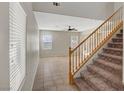 Bright living room showcasing a staircase, tile flooring, and plenty of natural light from large windows at 8040 Marshall Canyon Dr, Las Vegas, NV 89166