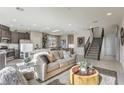 Open living area with modern sofa and kitchen views at 8405 Sycamore Creek St, Las Vegas, NV 89148