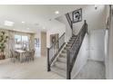 Modern staircase with dark wood railings and neutral carpeting at 8405 Sycamore Creek St, Las Vegas, NV 89148