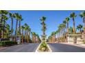 Attractive gated entrance to community with palm trees lining the driveway at 9050 W Warm Springs Rd # 1137, Las Vegas, NV 89148