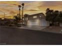 Front view of a two-story house with a three-car garage at 908 Primrose Ln, Henderson, NV 89011