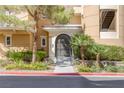 Elegant building entrance with gated access and landscaping at 9204 Tesoras Dr # 401, Las Vegas, NV 89144