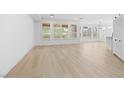 Bright living room with light hardwood floors and large windows at 10505 Novella Ct, Las Vegas, NV 89135