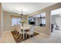 Formal dining room with a large table and chairs, and views to living room at 1125 Neva Ranch Ave, North Las Vegas, NV 89081