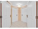 Bright entryway with two white doors and tiled floor at 135 E Harmon Ave # 718, Las Vegas, NV 89109