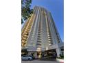 Tall, modern high-rise building with glass and balconies at 135 E Harmon Ave # 718, Las Vegas, NV 89109