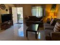 Bright living room with tiled floors and brown couches at 1806 Discus Dr, Las Vegas, NV 89108