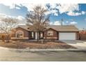 Attractive single-story home featuring desert landscaping, a two-car garage, and a well-maintained lawn at 210 Bristle Cone, Pahrump, NV 89048