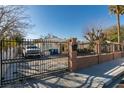 Home with a gated driveway and landscaped yard at 2116 Poplar Ave, Las Vegas, NV 89101