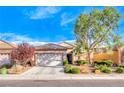 House exterior featuring a front yard and attached garage at 2571 Jada Dr, Henderson, NV 89044