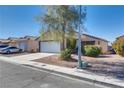 Quaint single-story home with a well-maintained front yard and a two-car attached garage at 2935 Kensington St, Las Vegas, NV 89156