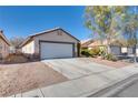 Inviting single-story home featuring a two-car garage, desert landscaping, and neutral color palette at 2935 Kensington St, Las Vegas, NV 89156