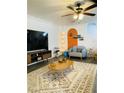 Living room featuring a large TV, comfy seating, and wood-look floors at 3495 Greenwood Springs Dr, Las Vegas, NV 89122