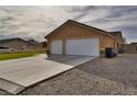 A two-car garage with a wide driveway and desert landscaping on a sunny day at 360 S Blagg Rd, Pahrump, NV 89048