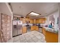 Well-lit kitchen with wooden cabinets, stainless steel appliances, and tile flooring at 360 S Blagg Rd, Pahrump, NV 89048