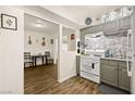 Well-equipped kitchen with gray cabinets, tile backsplash, and modern appliances at 3982 Voxna St, Las Vegas, NV 89119