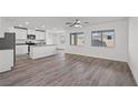 Open concept kitchen with island, white cabinets, and grey countertops at 4219 Gold Desert St, North Las Vegas, NV 89032