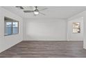 Spacious living room with grey vinyl flooring and a ceiling fan at 4219 Gold Desert St, North Las Vegas, NV 89032