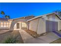 House exterior at night with arched entryway and lighted windows at 5117 Dancer Way, Las Vegas, NV 89107