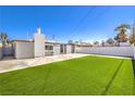 Large backyard featuring an artificial lawn and a patio area at 701 N Yale St, Las Vegas, NV 89107