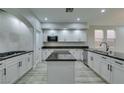 Modern kitchen featuring white cabinets, granite countertops, and stainless steel appliances at 7024 Bluebird Wing St, North Las Vegas, NV 89084