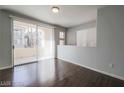 Living room with hardwood floors, sliding door to balcony at 7167 S Durango Dr # 203, Las Vegas, NV 89113