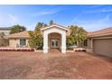 Charming single-story home featuring a welcoming entrance and well-manicured garden at 7450 Via Olivero Ave, Las Vegas, NV 89117