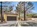 Front view of a tan house with a brown garage door at 7923 Canoe Ln, Las Vegas, NV 89145