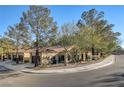 Spanish style home with a tile roof and landscaped yard at 7923 Canoe Ln, Las Vegas, NV 89145