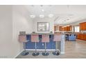 Modern kitchen bar with four pink velvet stools at 8 Hilltop Crest St, Henderson, NV 89011