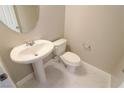 Small bathroom with pedestal sink and toilet at 8353 Stillhouse Ct, Las Vegas, NV 89113