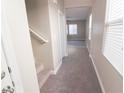 Interior hallway with carpeted floors and staircase at 8353 Stillhouse Ct, Las Vegas, NV 89113