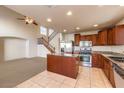 View of the kitchen and living room, showcasing tile floors and stainless steel appliances at 9328 Freedom Heights Ave, Las Vegas, NV 89149