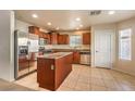 Kitchen area features an island, stainless steel appliances, and tile flooring at 9328 Freedom Heights Ave, Las Vegas, NV 89149