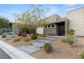 Stylish home with stone exterior and manicured landscaping at 10004 Terrastone Dr, Las Vegas, NV 89148