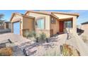One story house with blue garage door and red front door at 1290 El Solindo Ln, Henderson, NV 89002