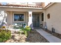 Inviting front porch with seating area, stone pathway, and landscaping at 1306 Big Tree Ave, North Las Vegas, NV 89031