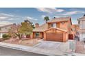 Two-story house with a brown garage door and desert landscaping at 1411 Bareback Ct, Henderson, NV 89014