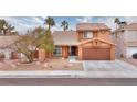 Two-story house with a tree, landscaping, and a brown garage door at 1411 Bareback Ct, Henderson, NV 89014