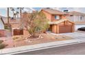 Two-story house with a tree in front and a landscaped yard at 1411 Bareback Ct, Henderson, NV 89014