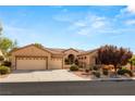 Single-story house with a three-car garage and beautifully landscaped front yard at 2563 Collinsville Dr, Henderson, NV 89052