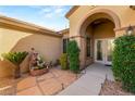 Inviting entryway with double doors, stone pathway, and lush landscaping at 2563 Collinsville Dr, Henderson, NV 89052