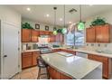 Kitchen with an island, stainless steel appliances, and wood cabinets at 2671 Colina Bella Ct, Las Vegas, NV 89142