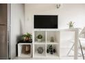 Living area with flat-screen TV and stylish storage shelving unit at 29 Montelago Blvd # 337, Henderson, NV 89011