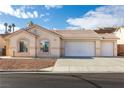 Single-story house with a two-car garage and desert landscaping at 2915 Rippling Springs St, Laughlin, NV 89029