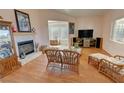 Living room featuring a fireplace, wood floors, and wicker furniture at 3821 S Tumbleweed Ave, Pahrump, NV 89048