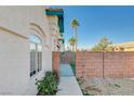 Side yard with gate and walkway leading to the house at 5040 Sublight Ave, Las Vegas, NV 89108