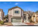 Two-story house with green garage door and landscaping at 5347 Reardon Ct, North Las Vegas, NV 89031